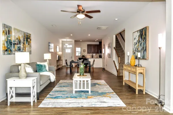 a living room with furniture fireplace view and wooden floor