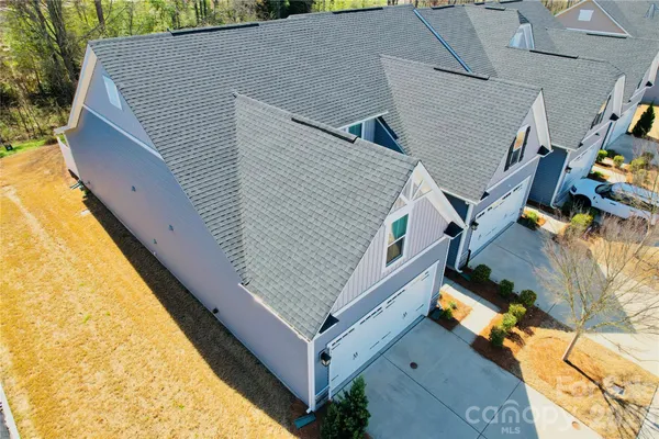 a aerial view of a house with large trees