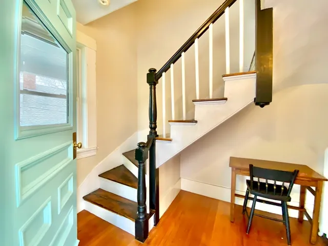 a view of entryway and hall with wooden floor