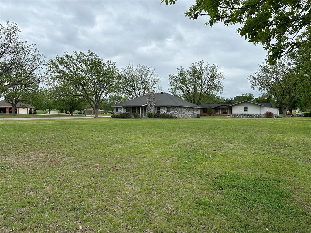 101 Player Street Comanche, TX 76442 - Photo 3 of 4 a view of a green field with house in the background
