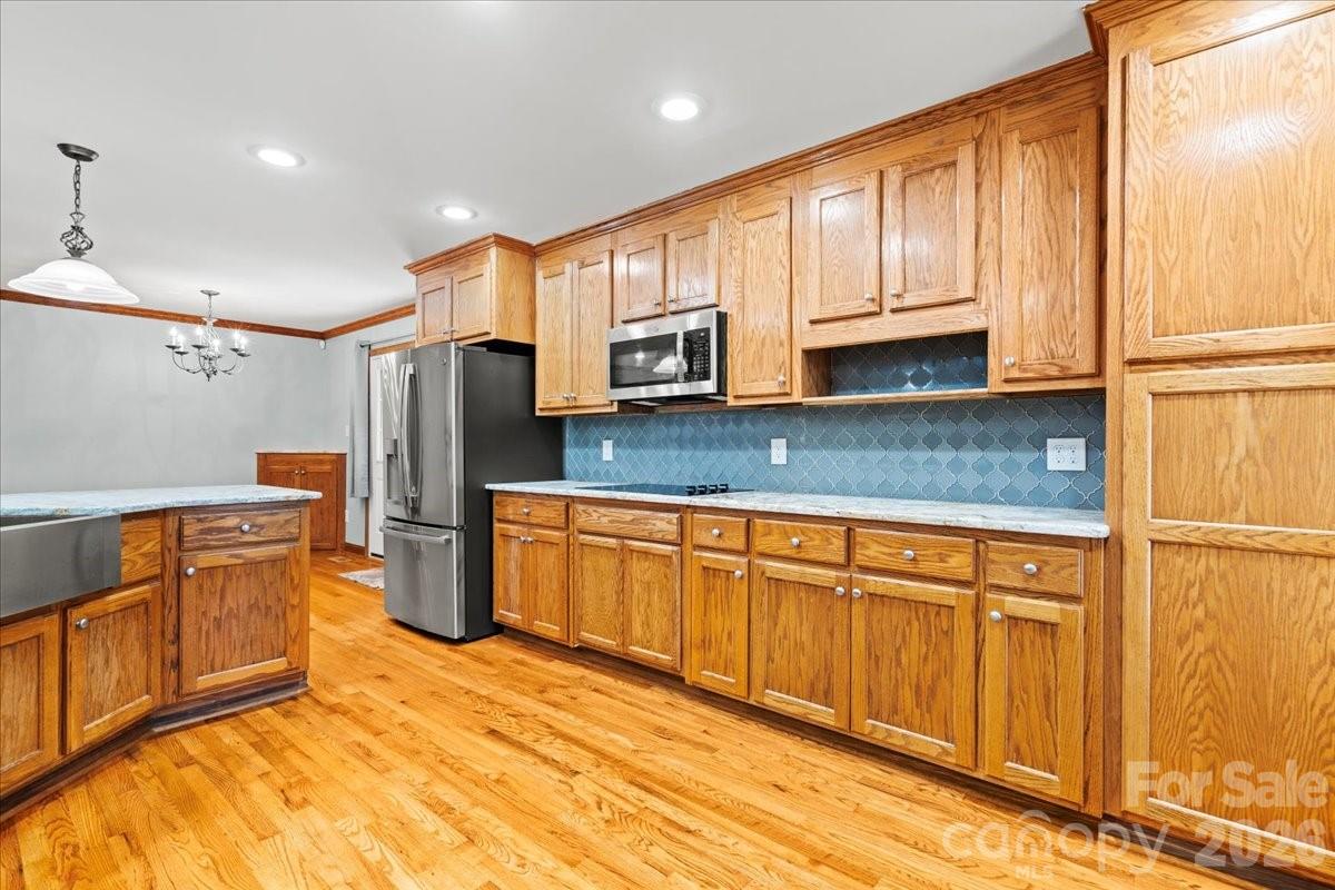 1935 Oakland Church Road Chesterfield, SC 29709 - Photo 13 of 48 a kitchen with stainless steel appliances granite countertop a refrigerator a stove a sink and dishwasher with wooden cabinets