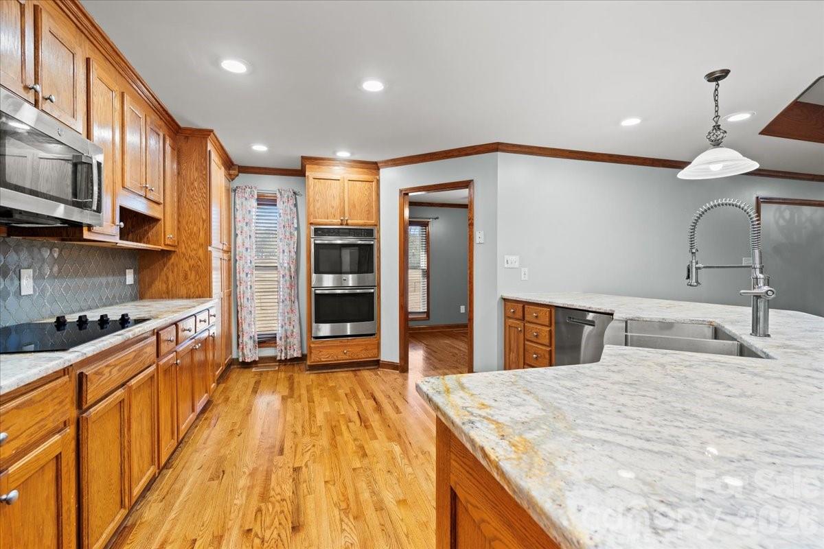 1935 Oakland Church Road Chesterfield, SC 29709 - Photo 14 of 48 a kitchen with stainless steel appliances granite countertop a sink a stove and a wooden floors
