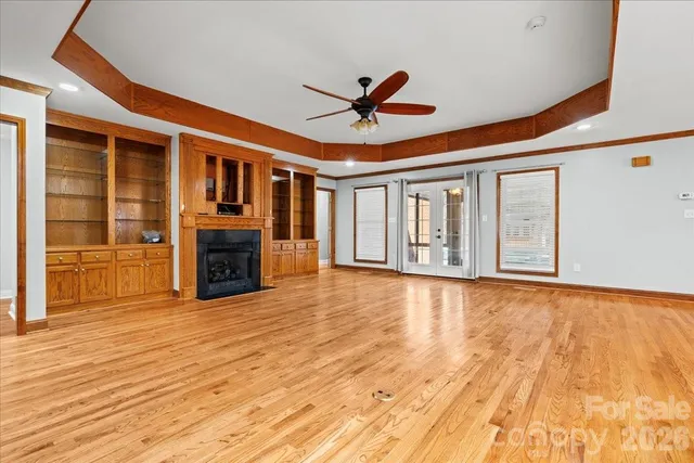 a view of a livingroom with a fireplace and wooden floor
