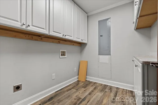 an empty room with wooden floor and window