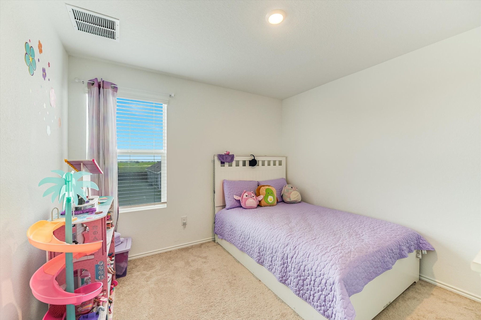 2223 Cumulus Court Lockhart, TX 78644 - Photo 16 of 20 a bedroom with a bed and a potted plant