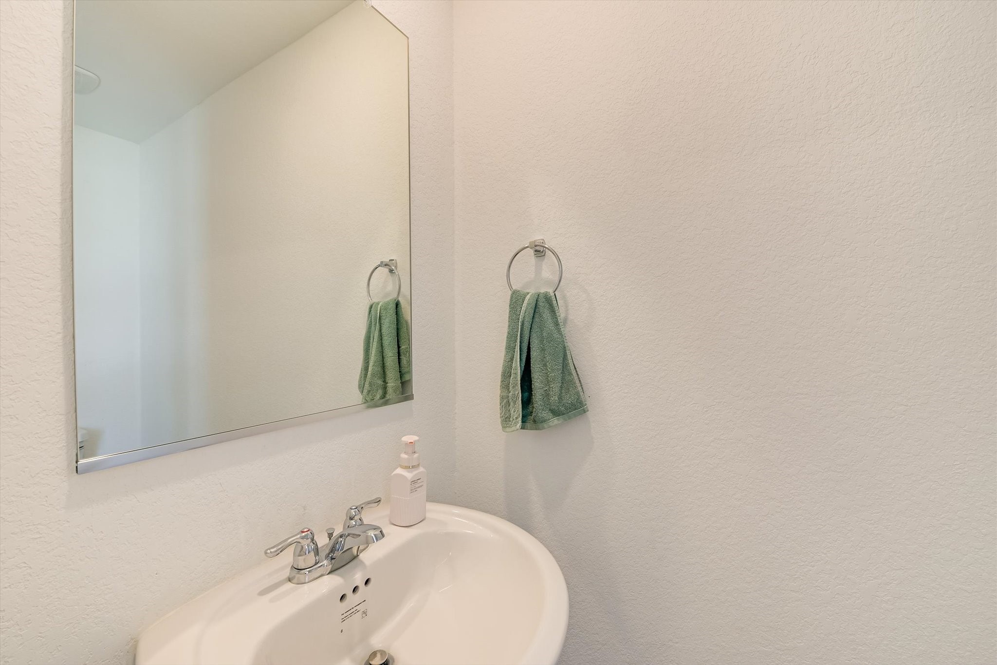 2223 Cumulus Court Lockhart, TX 78644 - Photo 18 of 20 a bathroom with a sink and mirror