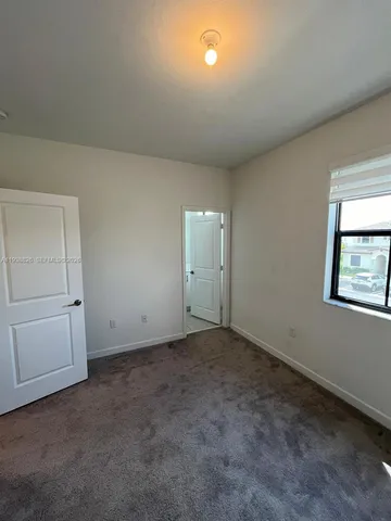 an empty room with closet and window