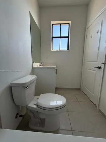 a white toilet sitting next to a bathroom sink