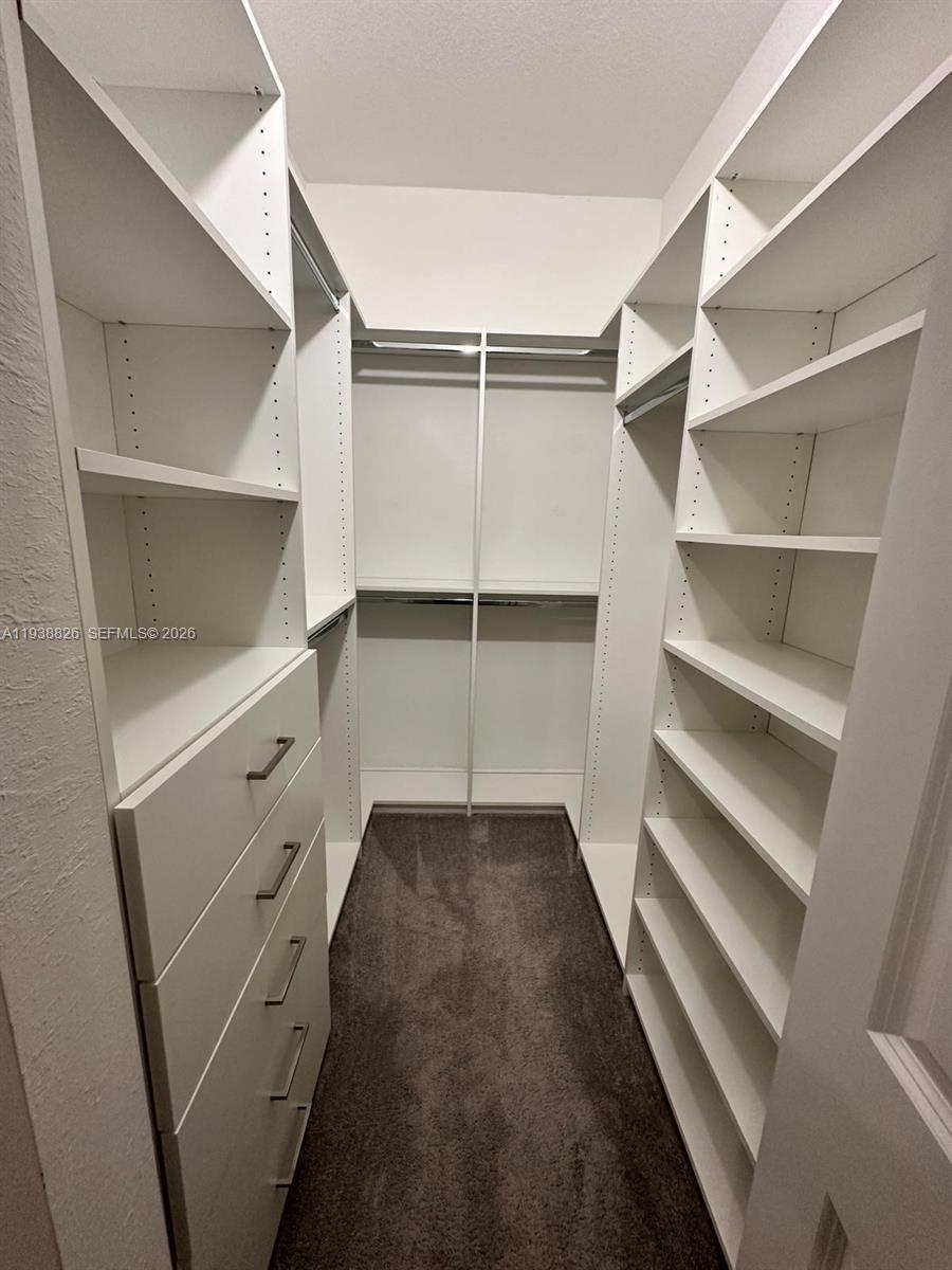9941 Southwest 228th Terrace, Unit 9941 Miami, FL 33190 - Photo 18 of 31 a view of an empty walk in closet
