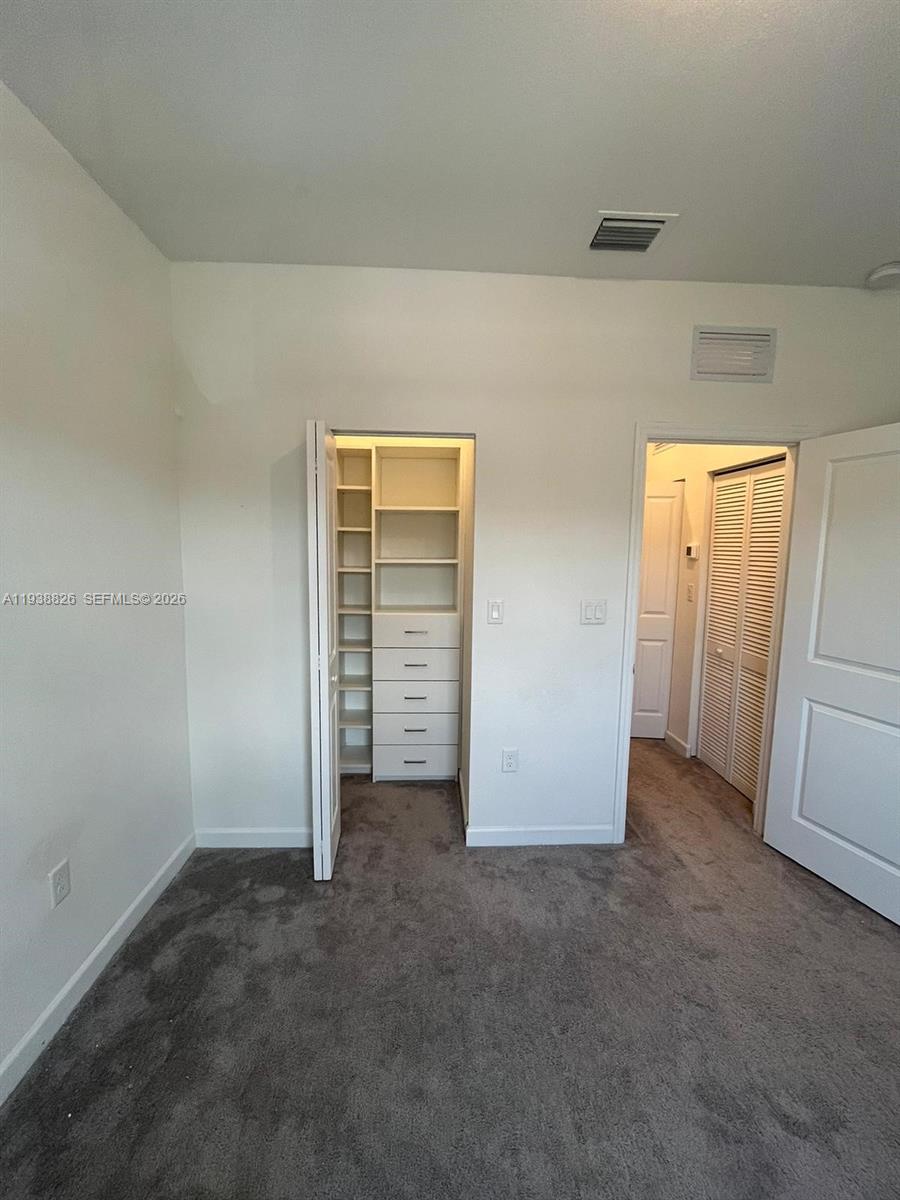 9941 Southwest 228th Terrace, Unit 9941 Miami, FL 33190 - Photo 19 of 31 an empty room with closet