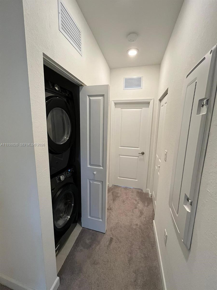 9941 Southwest 228th Terrace, Unit 9941 Miami, FL 33190 - Photo 25 of 31 a view of a storage & utility room with washer and dryer