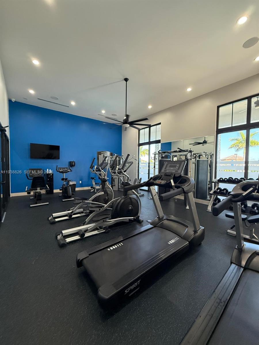 9941 Southwest 228th Terrace, Unit 9941 Miami, FL 33190 - Photo 27 of 31 a view of a room with gym equipment