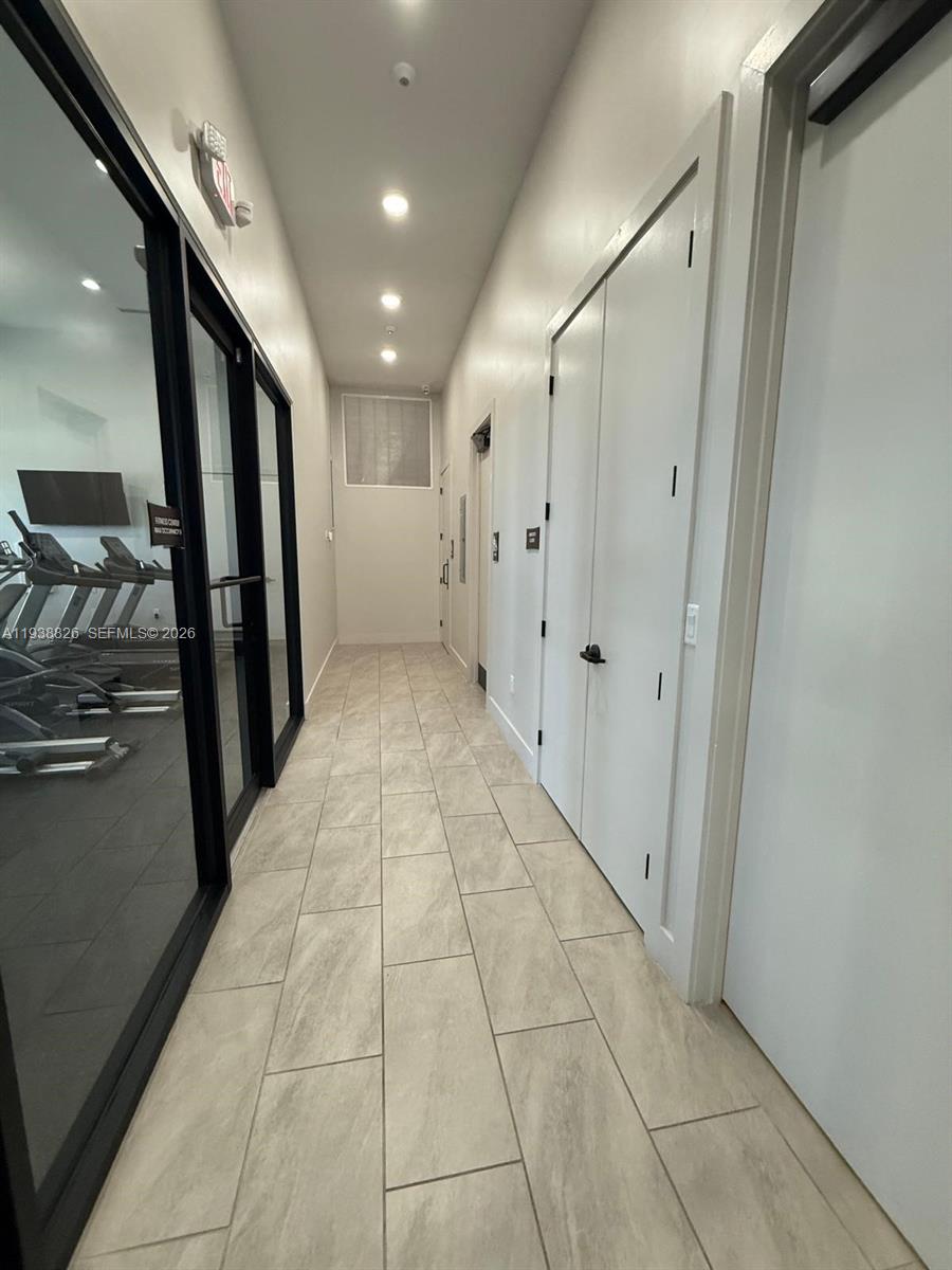 9941 Southwest 228th Terrace, Unit 9941 Miami, FL 33190 - Photo 28 of 31 a view of hallway with stairs