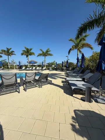 a swimming pool with outdoor seating and yard