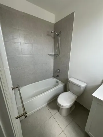 a white toilet sitting next to a bath tub