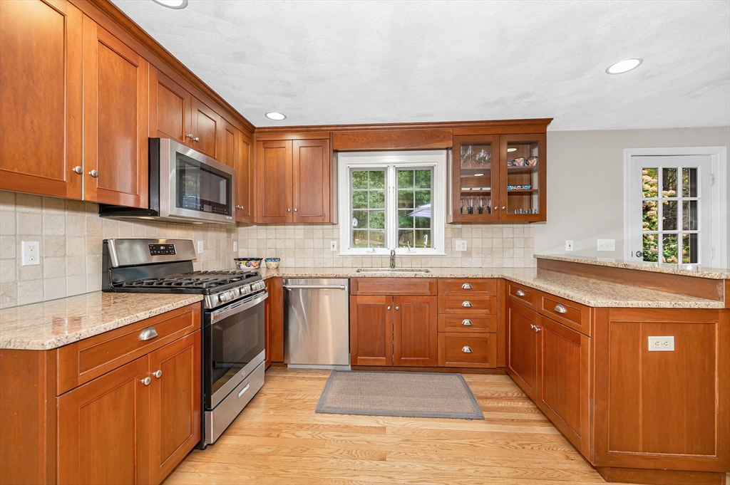 4 Coleman Road Newbury, MA 01922 - Photo 12 of 42 a large kitchen with stainless steel appliances granite countertop a stove sink and cabinets