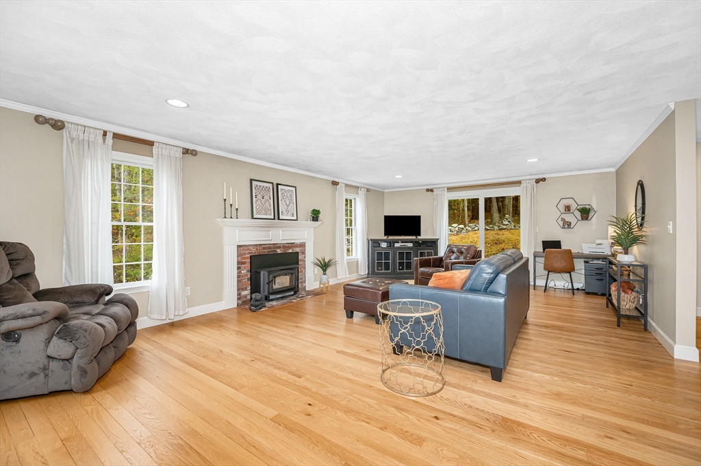 4 Coleman Road Newbury, MA 01922 - Photo 15 of 42 a living room with furniture a fireplace and a flat screen tv
