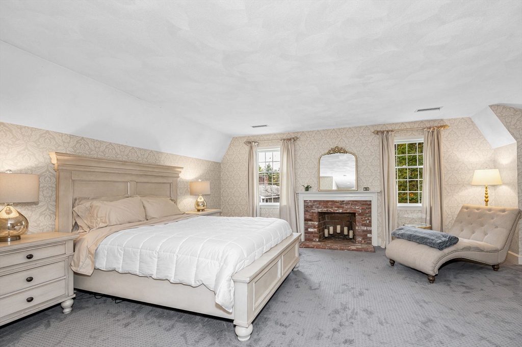 4 Coleman Road Newbury, MA 01922 - Photo 19 of 42 a bedroom with a bed fireplace and a couch