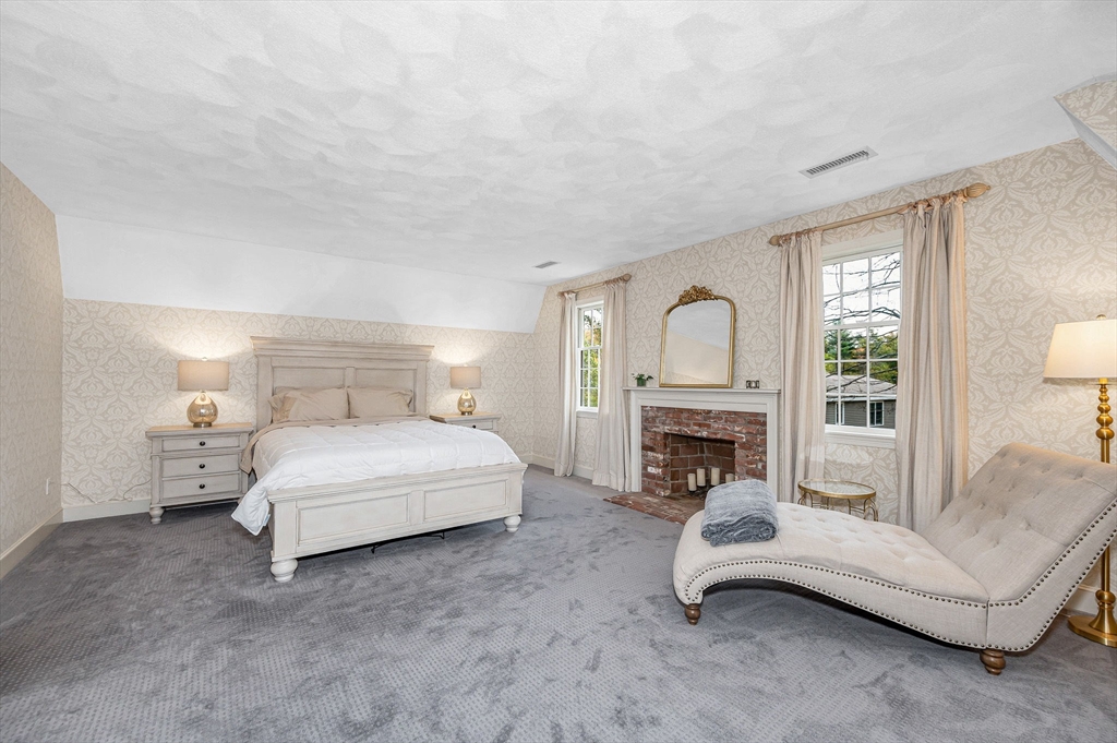 4 Coleman Road Newbury, MA 01922 - Photo 20 of 42 a spacious bedroom with a bed and a fireplace