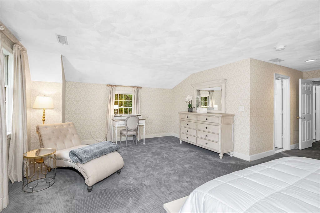 4 Coleman Road Newbury, MA 01922 - Photo 21 of 42 a spacious bedroom with a bed and a couch