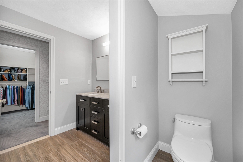 4 Coleman Road Newbury, MA 01922 - Photo 22 of 42 a bathroom with a toilet a sink a vanity and mirror