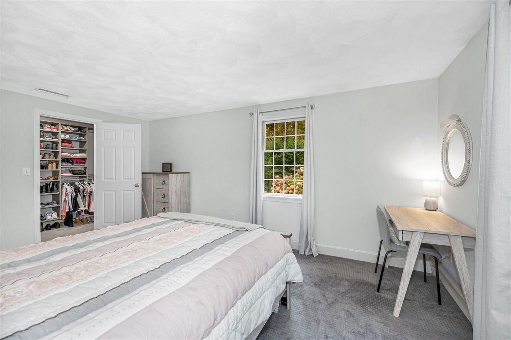 4 Coleman Road Newbury, MA 01922 - Photo 27 of 42 a bedroom with a bed a table and painting on the wall