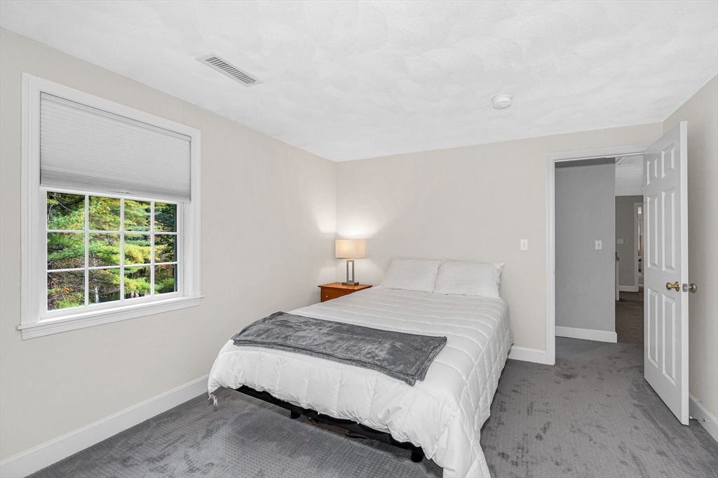 4 Coleman Road Newbury, MA 01922 - Photo 29 of 42 a bedroom with a bed and a window
