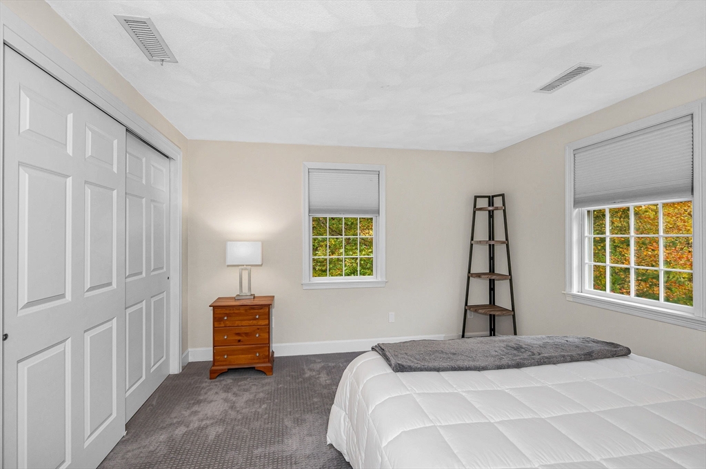 4 Coleman Road Newbury, MA 01922 - Photo 30 of 42 a spacious bedroom with a bed and a window