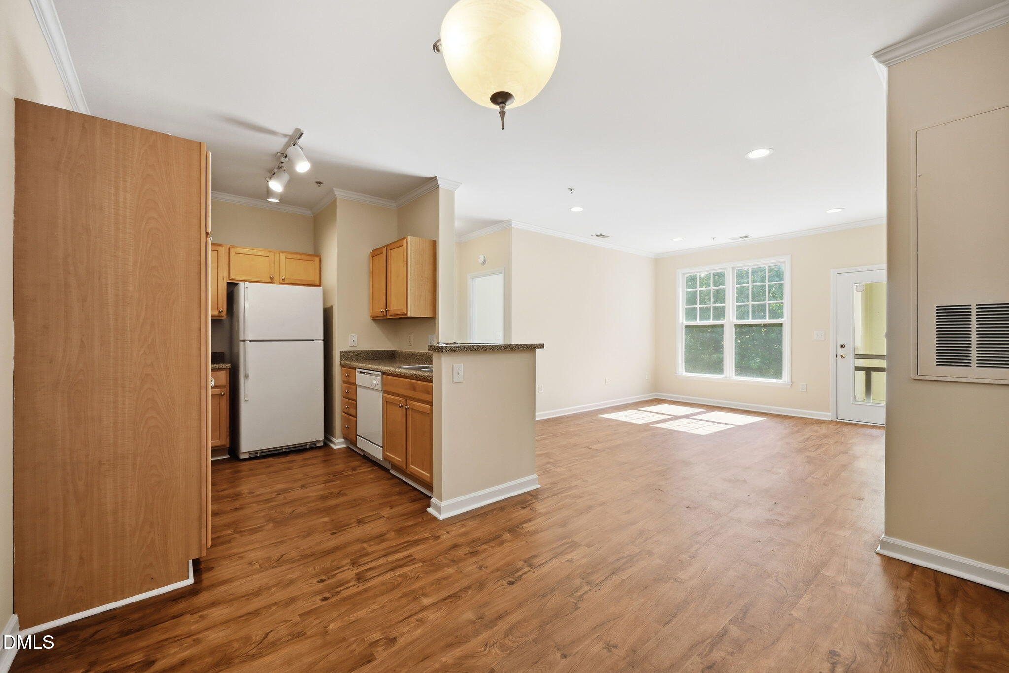 801 Moratuck Drive, Unit 202 Raleigh, NC 27604 - Photo 8 of 23 a view of a kitchen with a refrigerator and a stove top oven