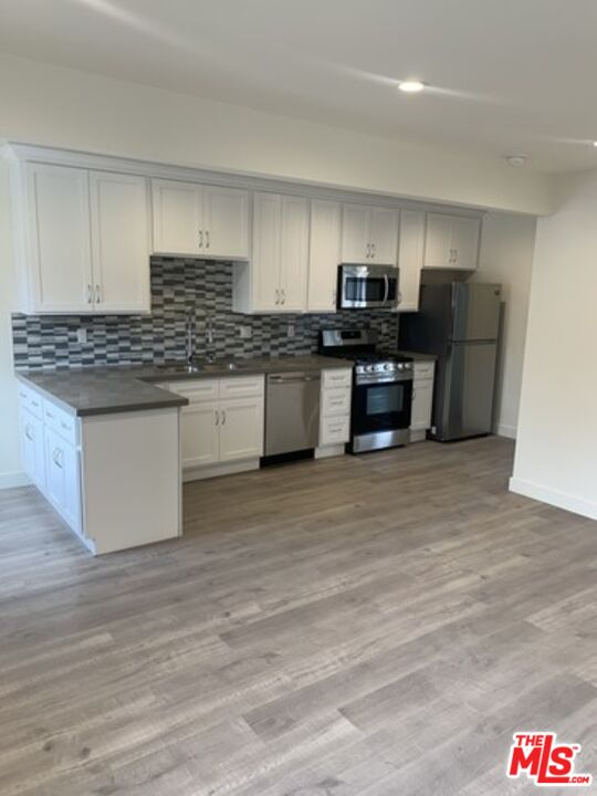 a kitchen with stainless steel appliances granite countertop a stove and a sink