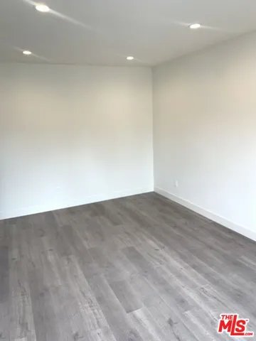 an empty room with wooden floor