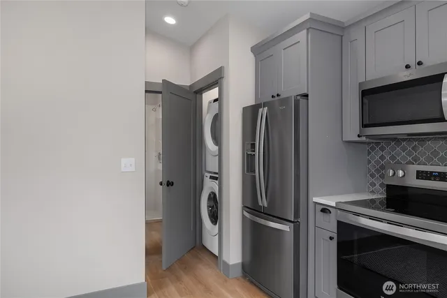 a metallic refrigerator freezer sitting in a kitchen