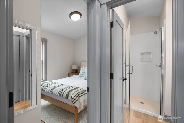 a bedroom with a bed and a shower