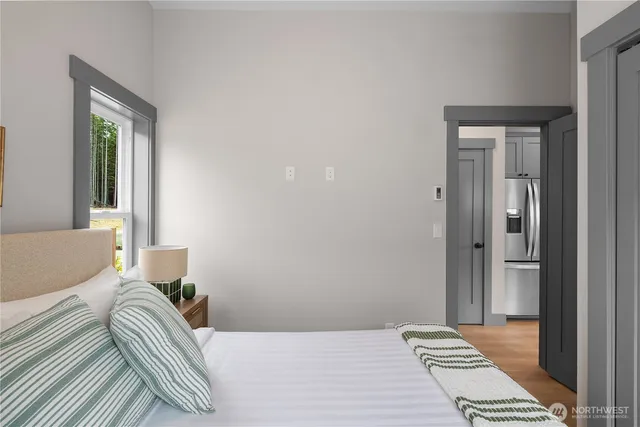 a bedroom with a bed and a window