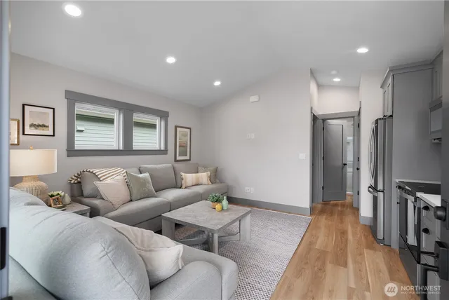 a living room with furniture and a wooden floor