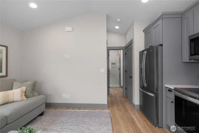 a kitchen with stainless steel appliances a refrigerator and a stove top oven