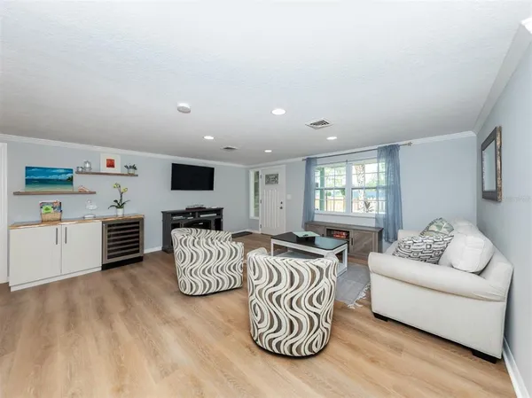 a living room with furniture and a wooden floor