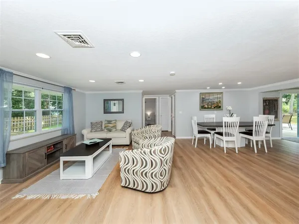 a living room with furniture flat screen tv and couches