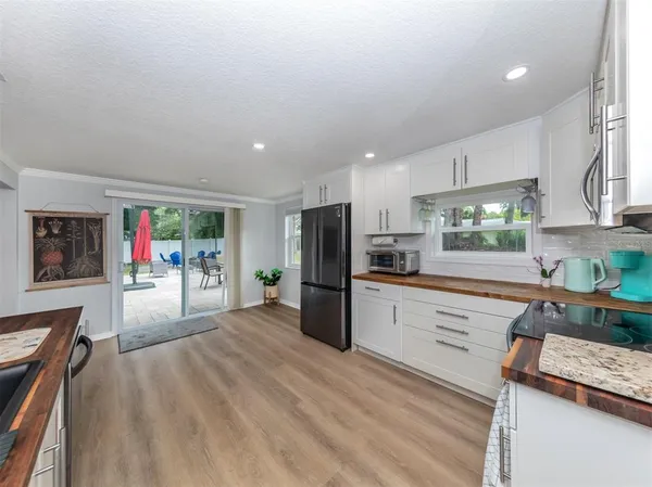 a kitchen with a sink cabinets and appliances