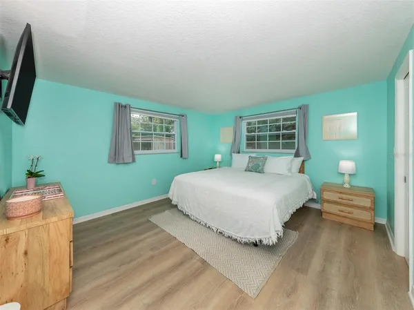 a spacious bedroom with a bed and a table