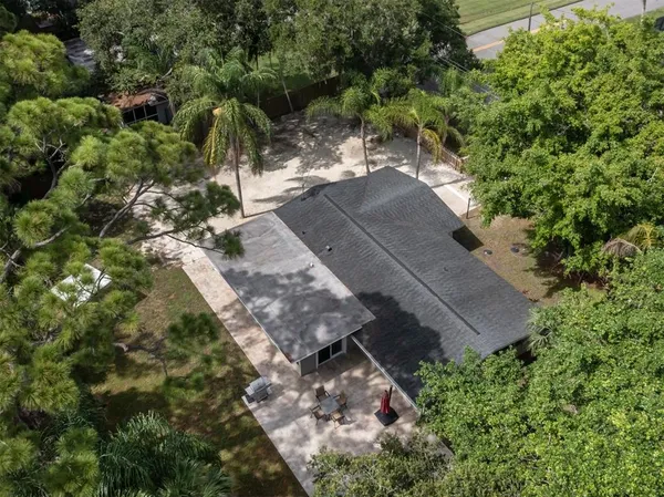 a view of a swimming pool with a lounge chair and garden