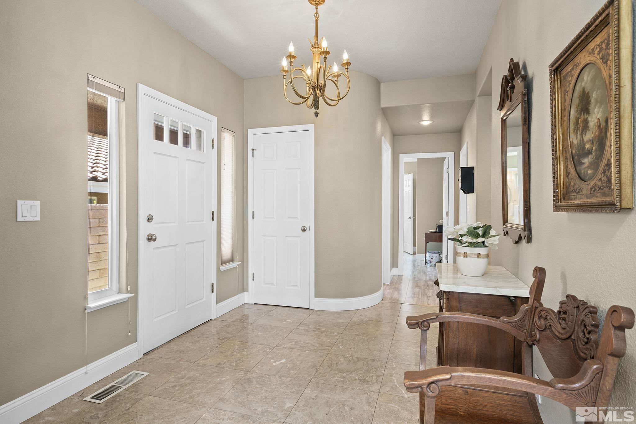 2553 Granite Springs Road Reno, NV 89519 - Photo 12 of 38 a living room with furniture a chandelier and a window
