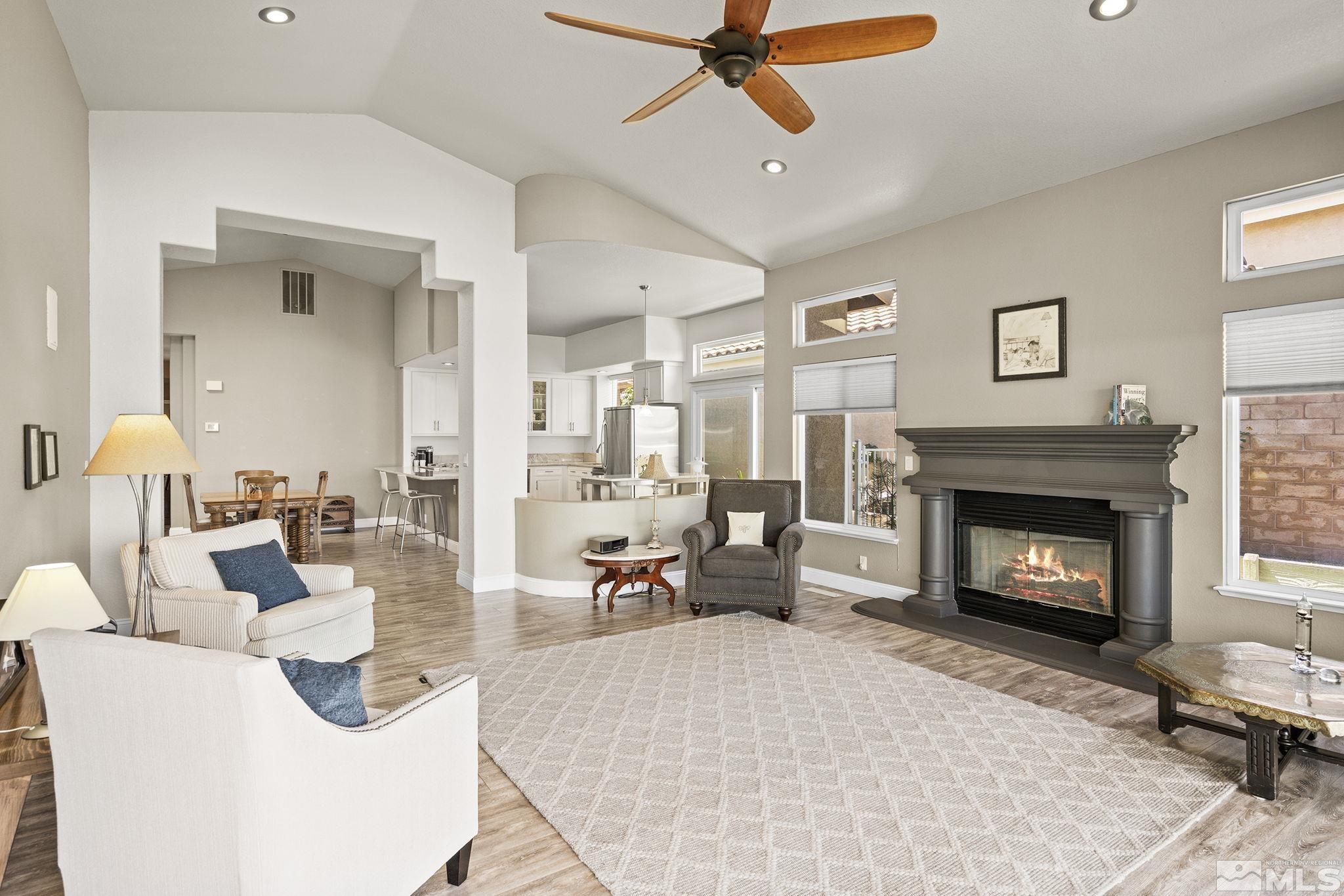 2553 Granite Springs Road Reno, NV 89519 - Photo 15 of 38 a living room with furniture a fireplace and a window