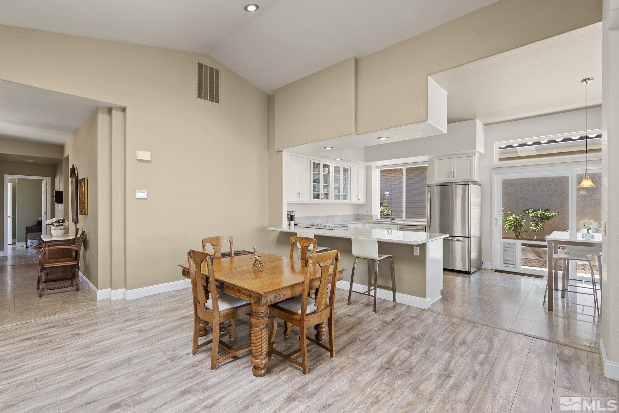 2553 Granite Springs Road Reno, NV 89519 - Photo 16 of 38 a view of a dining room with furniture and wooden floor