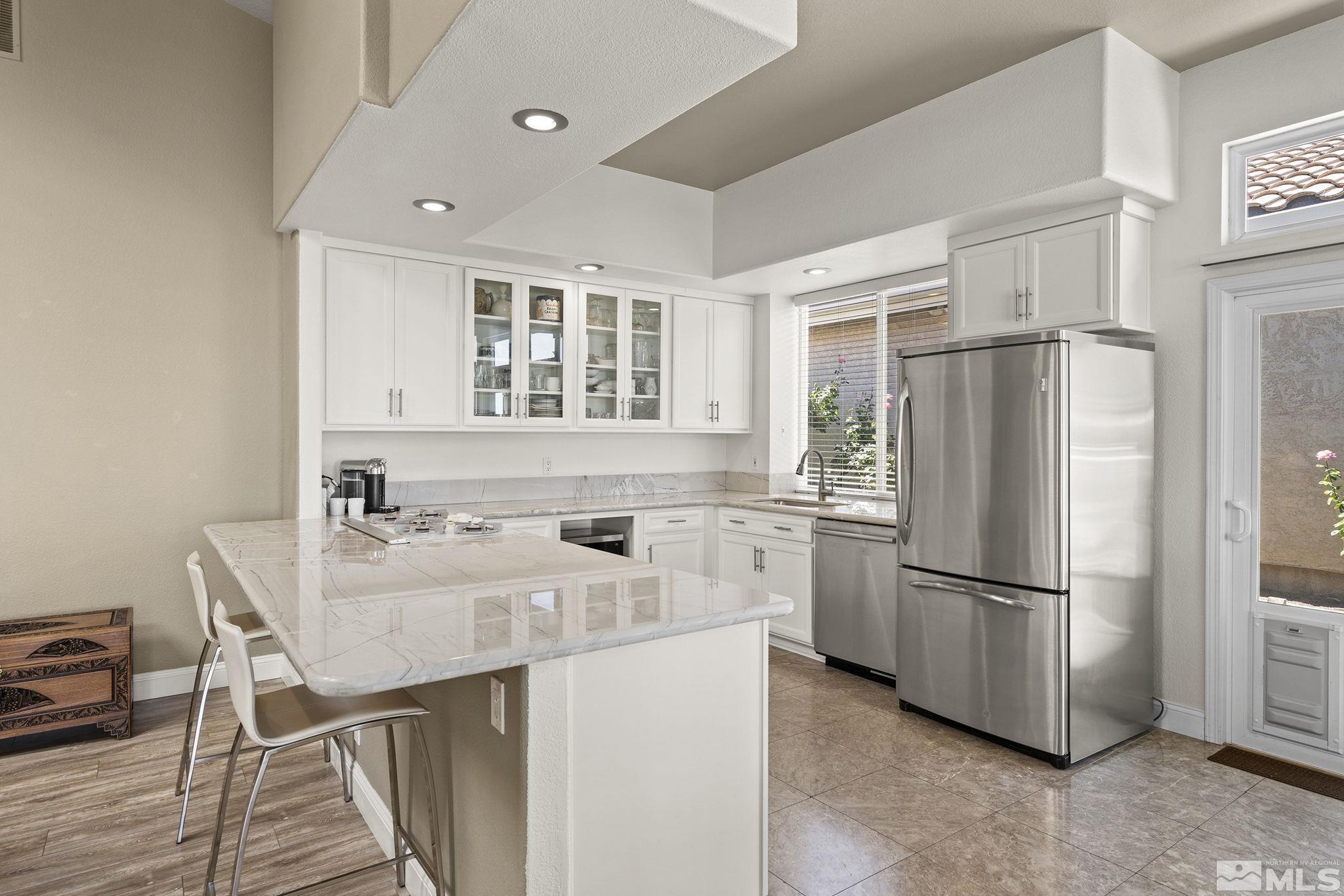2553 Granite Springs Road Reno, NV 89519 - Photo 18 of 38 a kitchen with stainless steel appliances a refrigerator a stove a sink and a refrigerator