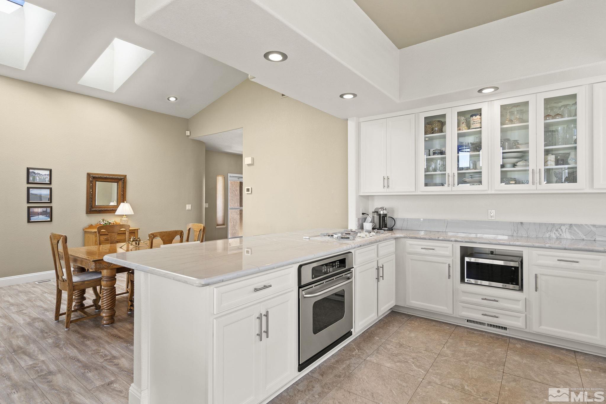 2553 Granite Springs Road Reno, NV 89519 - Photo 20 of 38 a kitchen that has a lot of white cabinets and stainless steel appliances