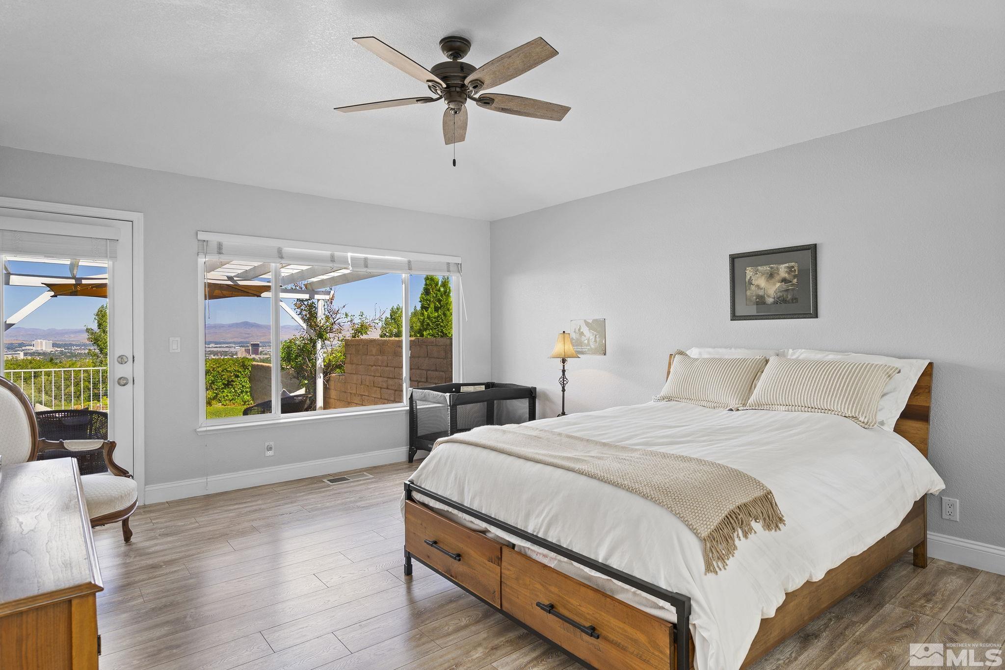 2553 Granite Springs Road Reno, NV 89519 - Photo 22 of 38 a bedroom with a large bed and a large window