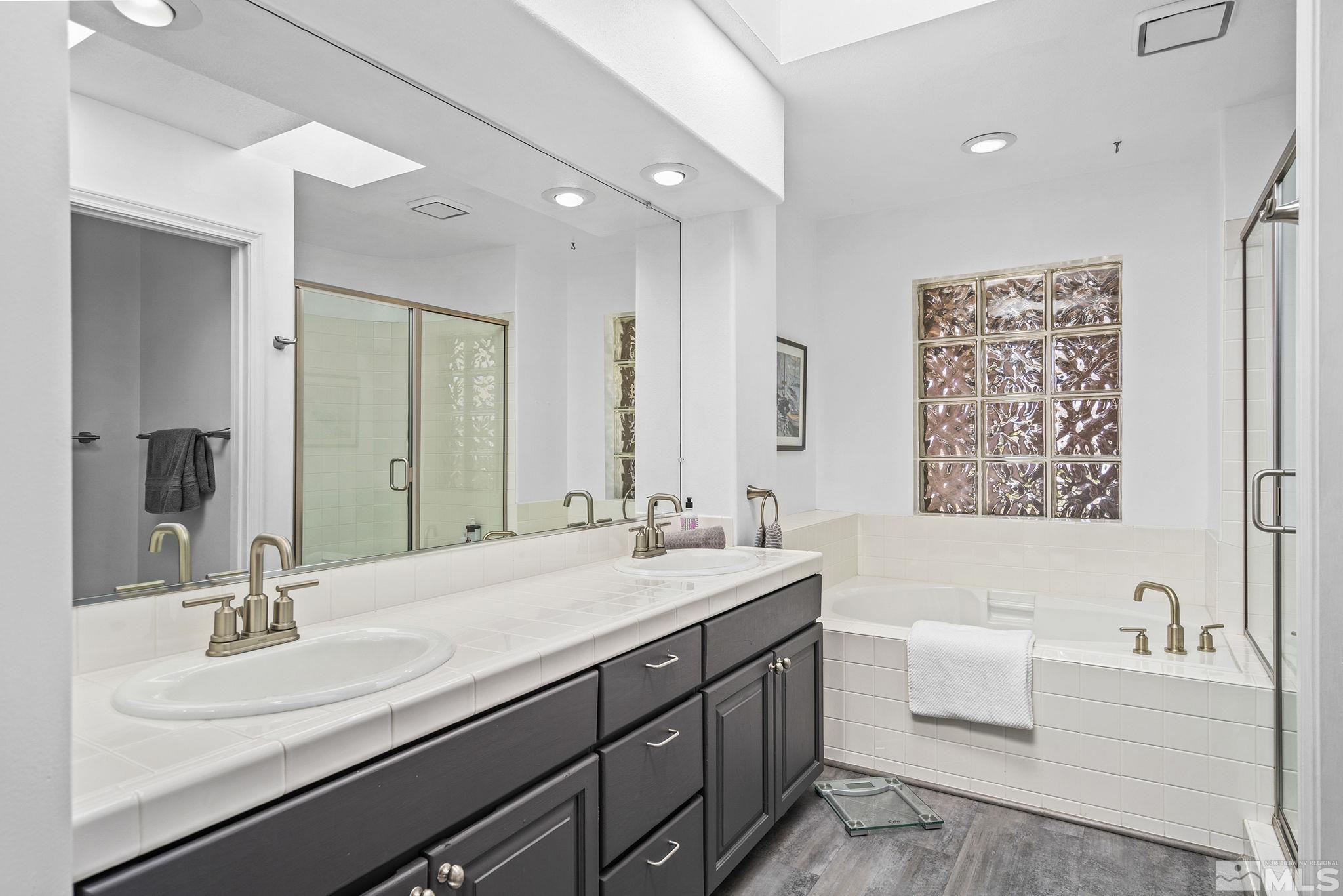 2553 Granite Springs Road Reno, NV 89519 - Photo 24 of 38 a bathroom with a bathtub double sink and mirror