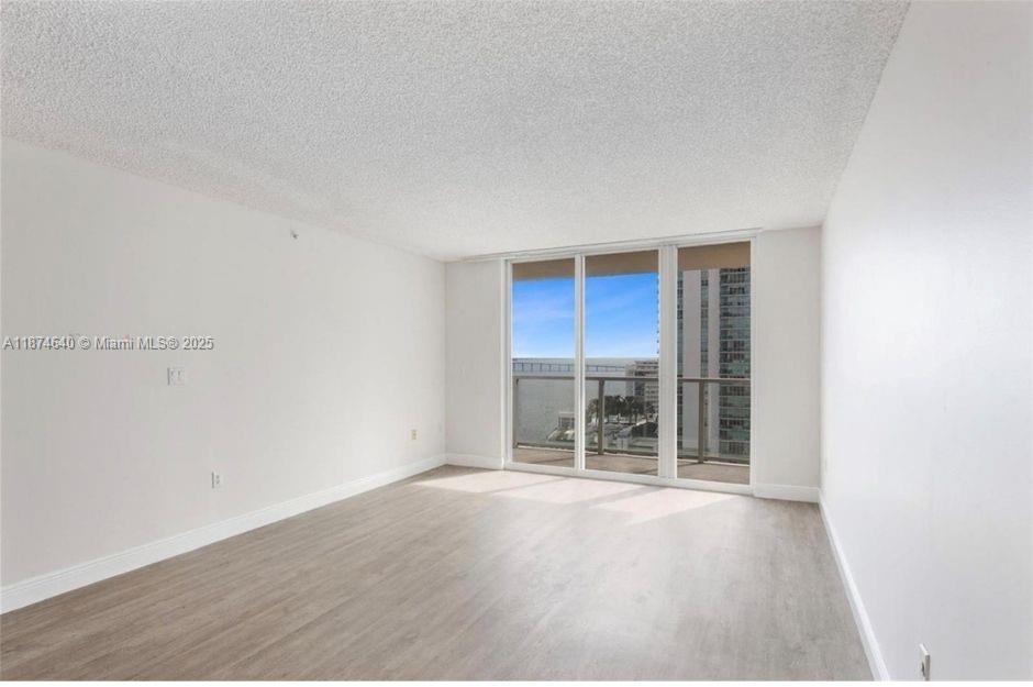 1155 Brickell Bay Drive, Unit 1705 Miami, FL 33131 - Photo 2 of 8 an empty room with windows