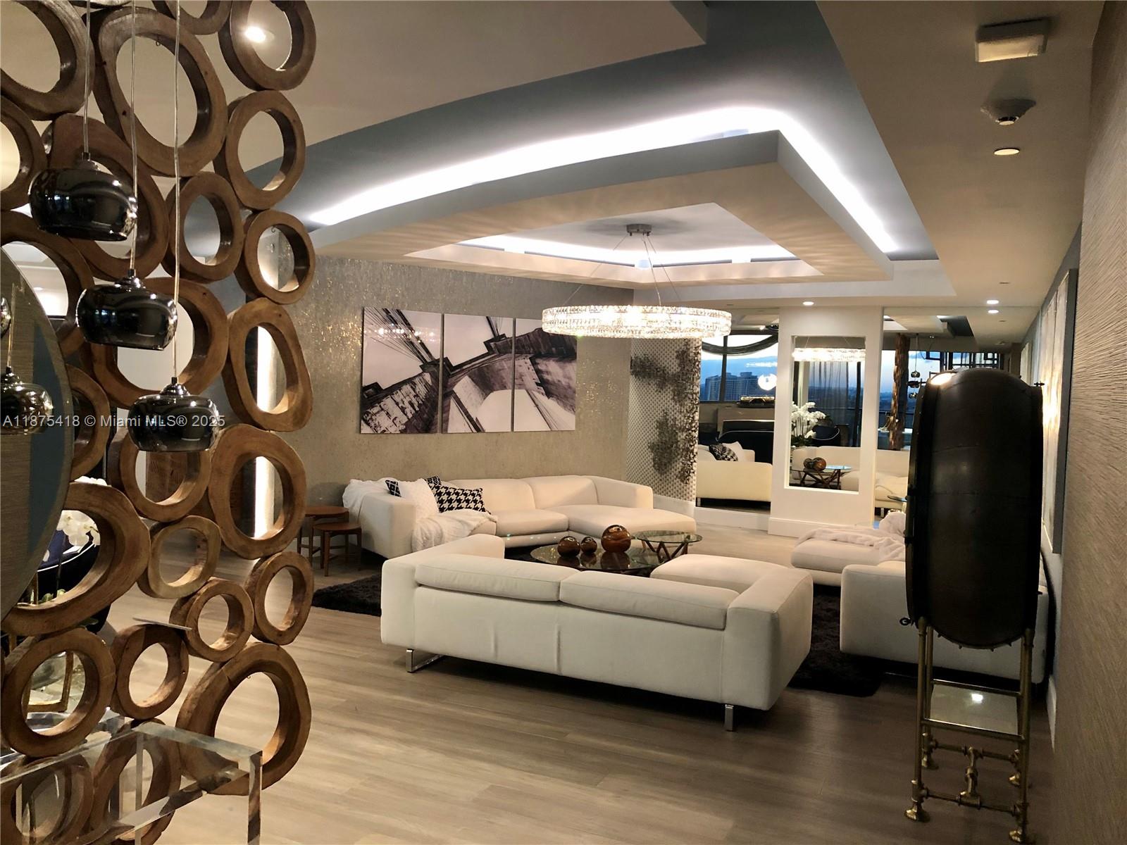 a living room with furniture and a floor to ceiling window